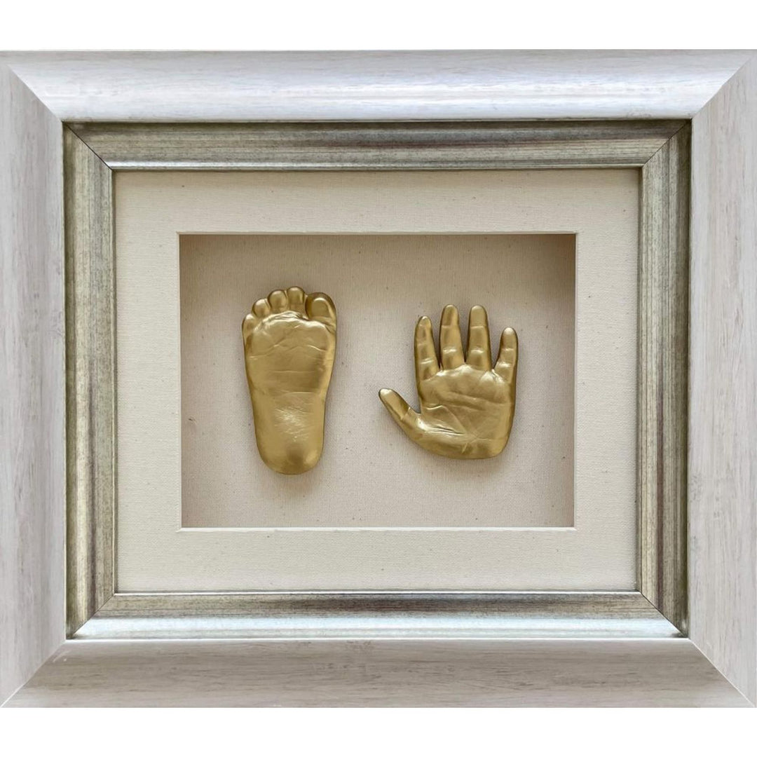 Gold baby foot and hand prints in a framed display