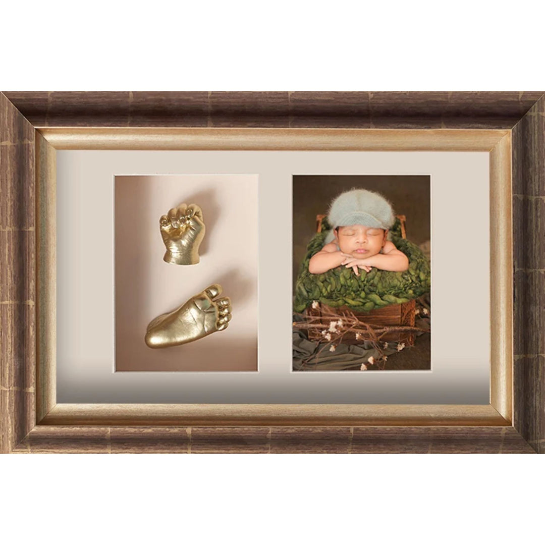 Framed artwork with gold baby footprints and a photo of a baby in a green outfit.