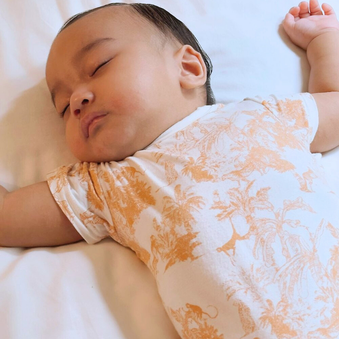 Baby wearing Little Noah Orange Bamboo Safari Classic Romper