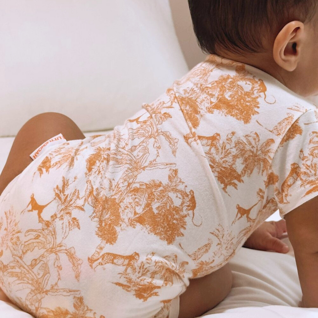 Baby wearing Little Noah Orange Bamboo Safari Classic Romper