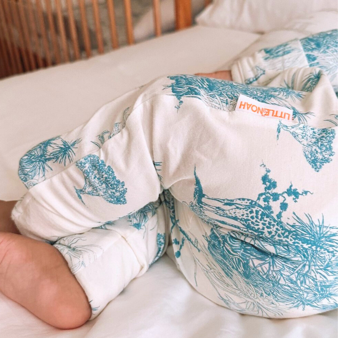 Baby wearing Little Noah Blue Bamboo Safari Sleepsuit
