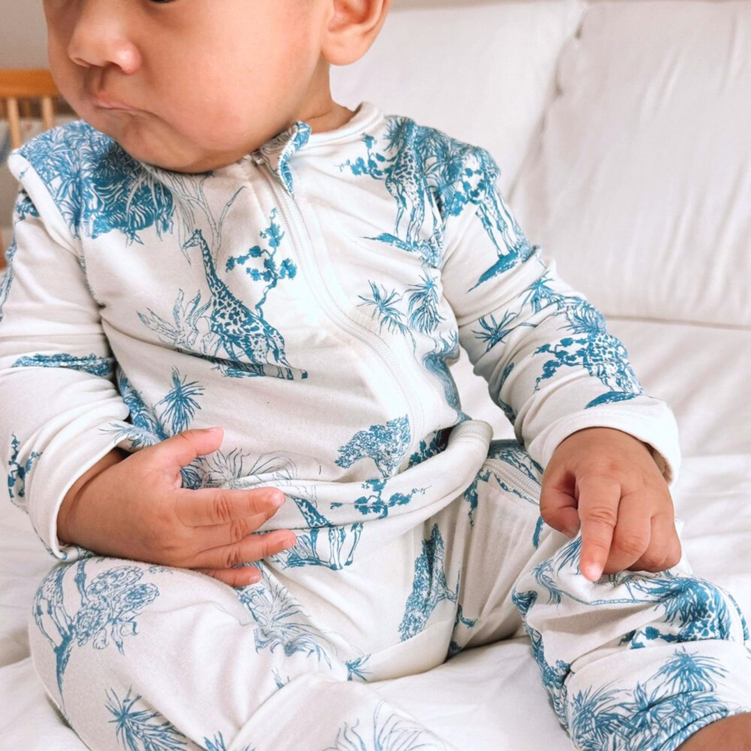 Baby wearing Little Noah Blue Bamboo Safari Sleepsuit