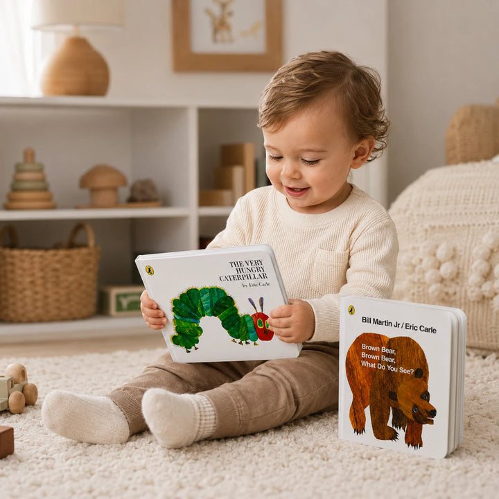 Toddler Reading The Very Hungry Caterpillar Board Book with Brown Bear Book Beside Them