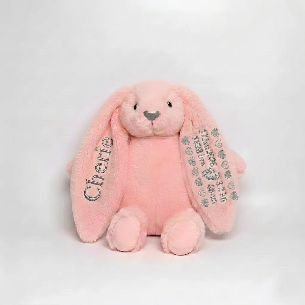 Pink plush bunny with 'Cherie' on one ear and another with birth details