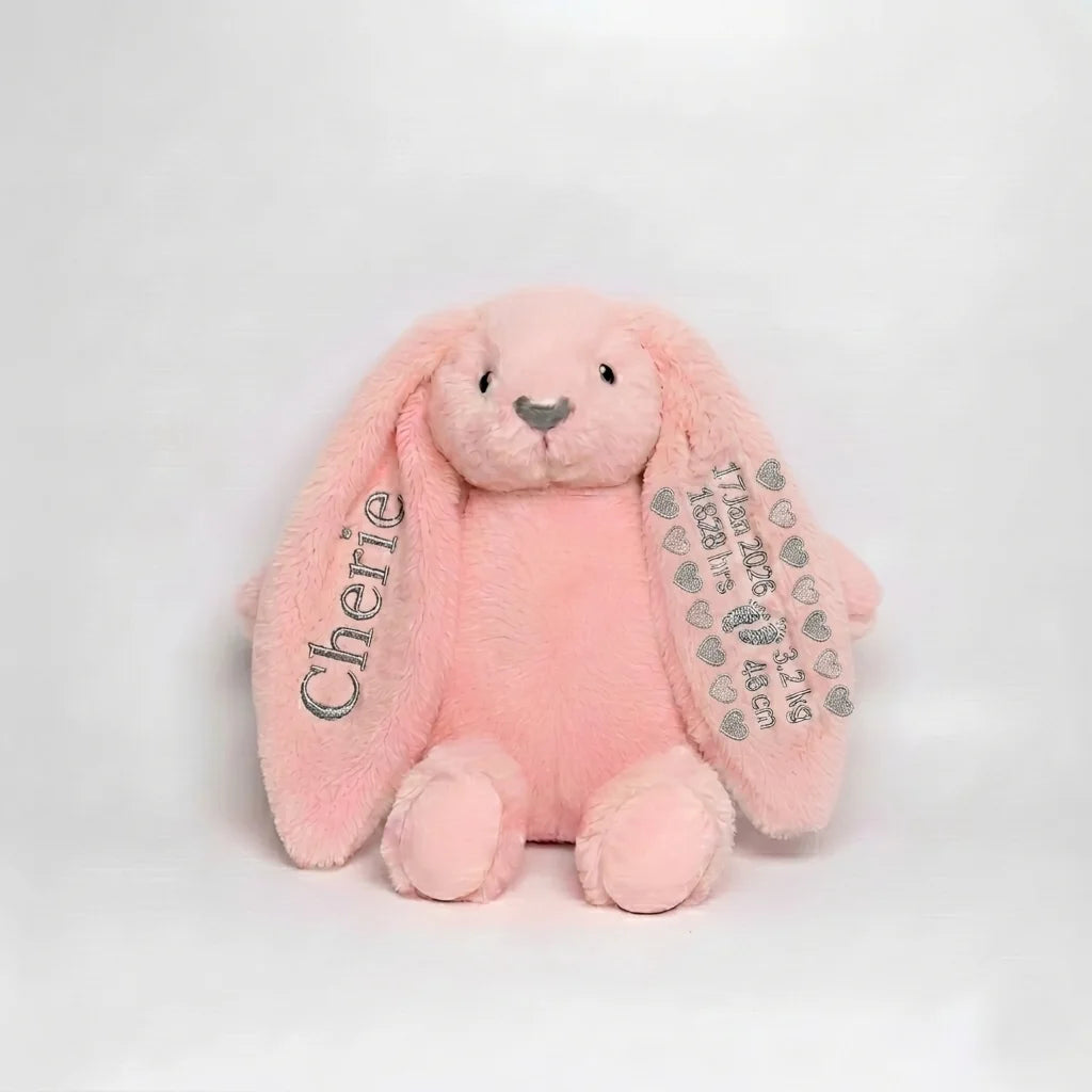 Pink plush bunny with 'Cherie' on one ear and another with birth details