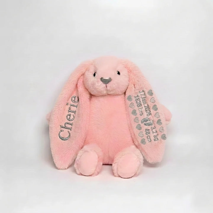 Pink plush bunny with 'Cherie' on one ear and another with birth details