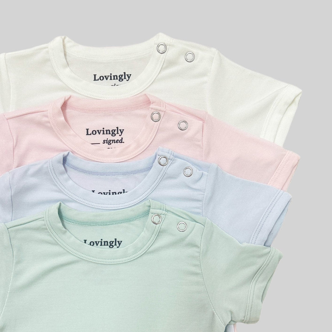 Closeup of bamboo babygrow in 4 colours