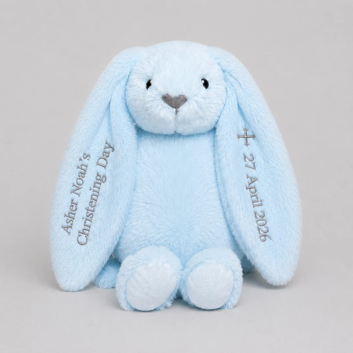 Blue plush bunny with personalised name and date for christening day on a light gray background