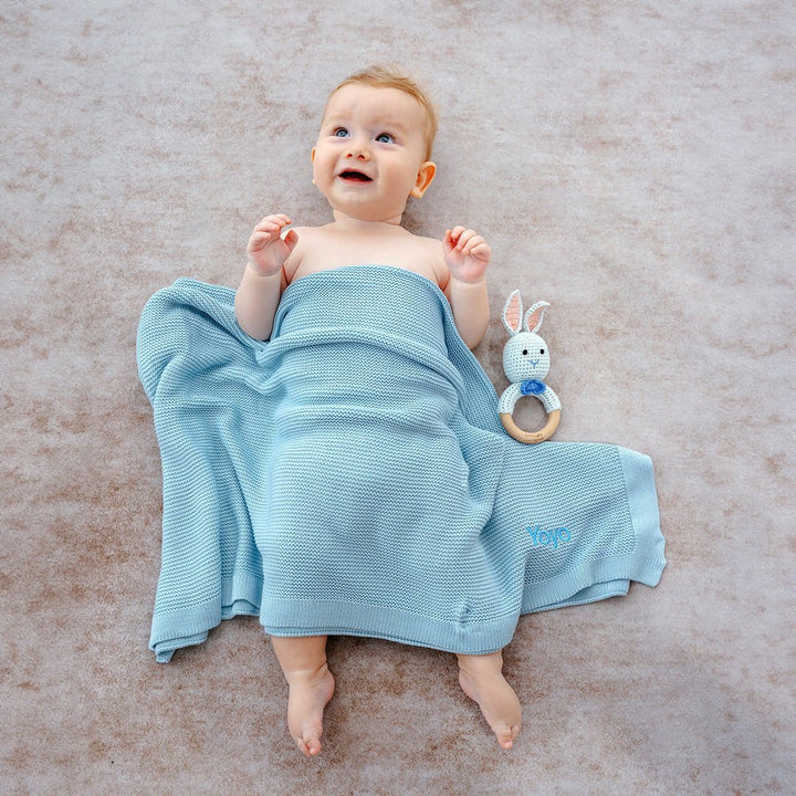 Baby covering in Blue Bamboo Blanket with Blue Bunny Rattle