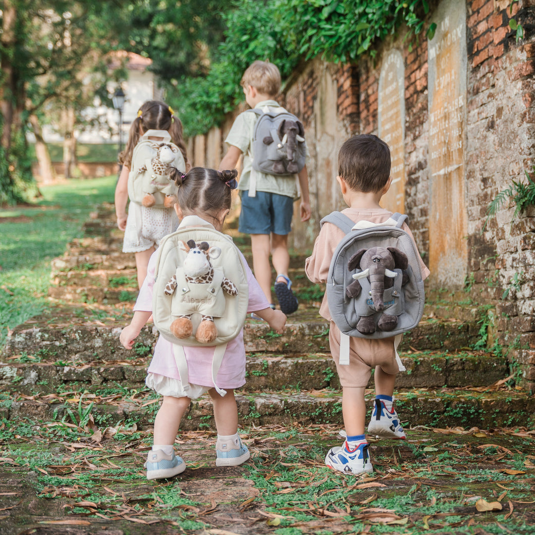 children carrying personalised backpacks with softtoy