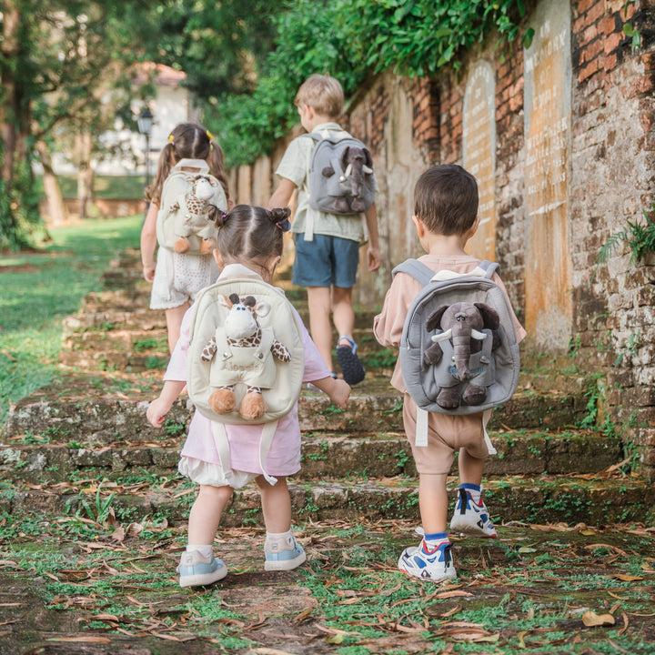 children carrying personalised backpacks with softtoy