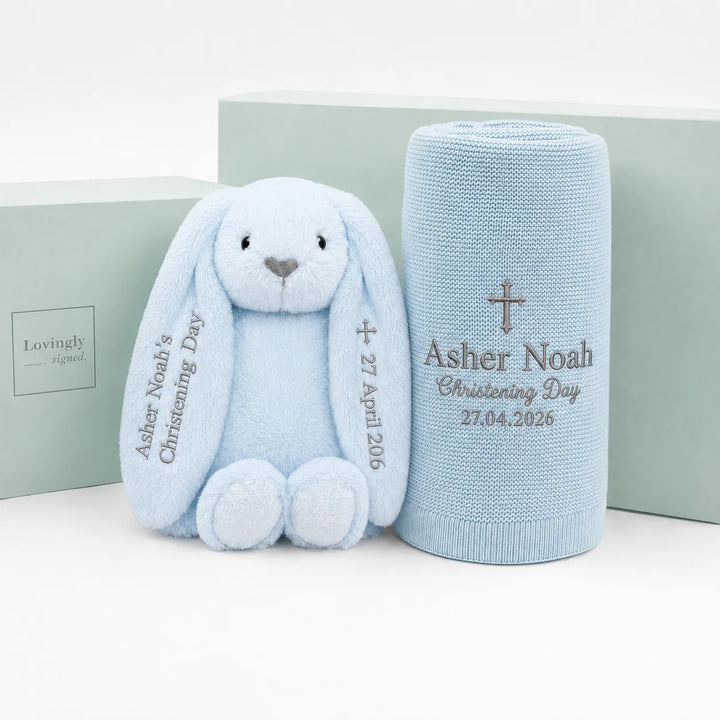 Personalized baby Christening gift set featuring a light blue plush bunny and a matching light blue knit blanket, both embroidered with the name 'Asher Noah', 'Christening Day', and the date '27.04.
