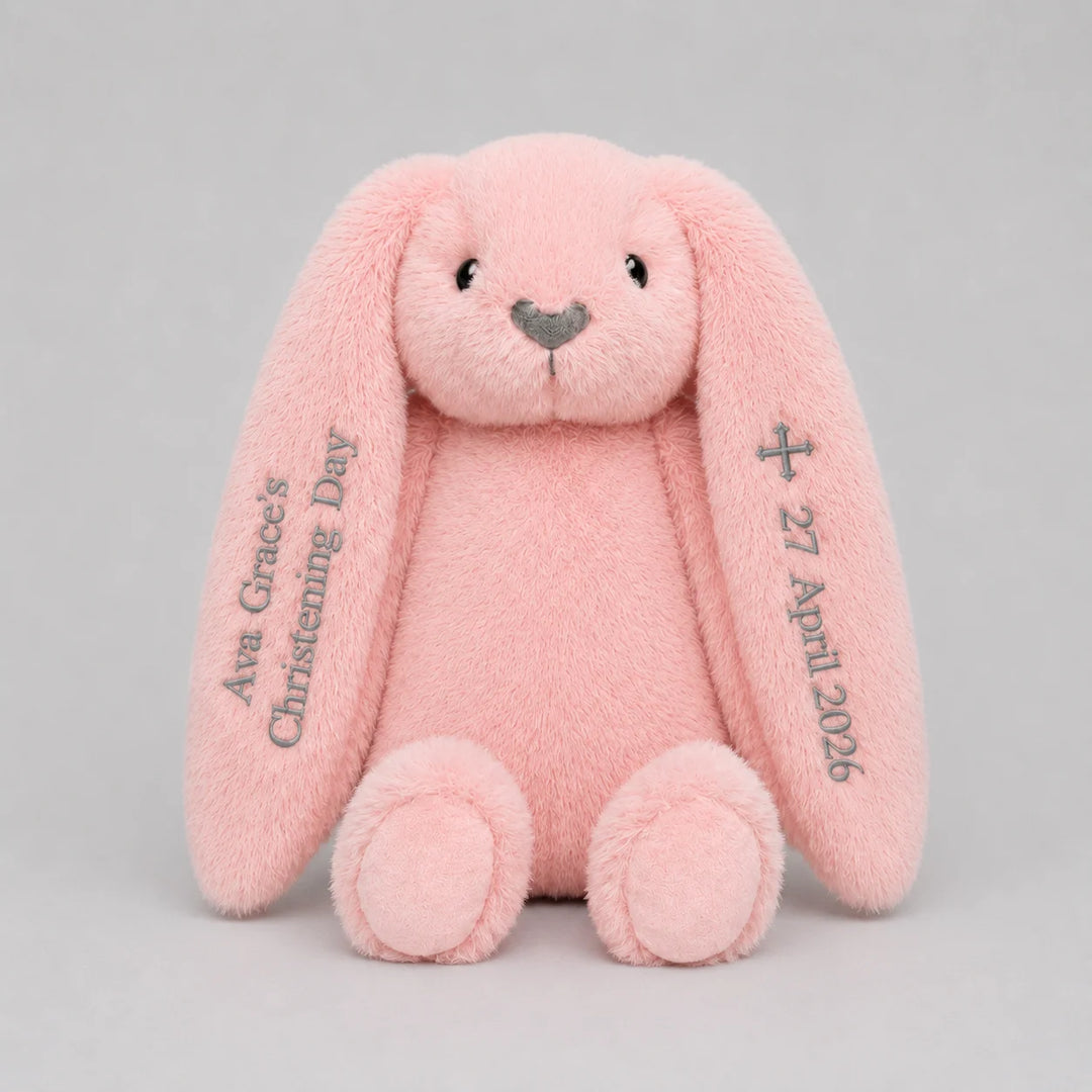 Pink plush bunny with personalised name and date for christening day on a light gray background