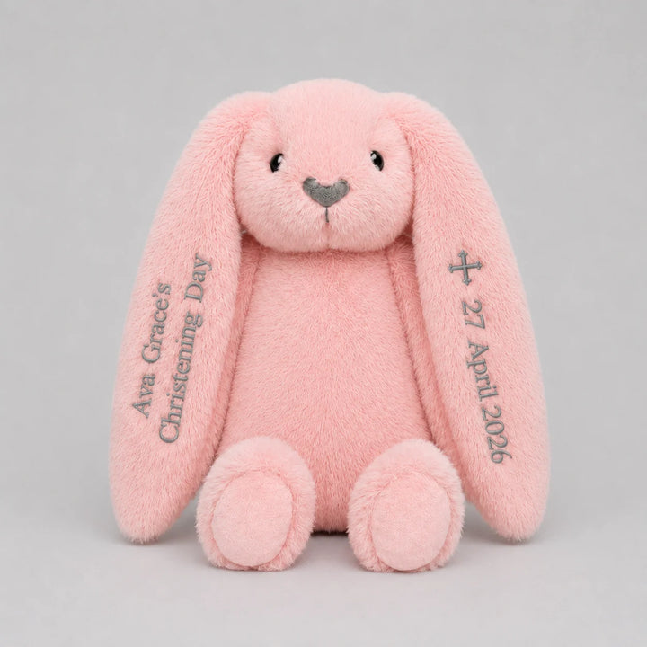 Pink plush bunny with personalised name and date for christening day on a light gray background
