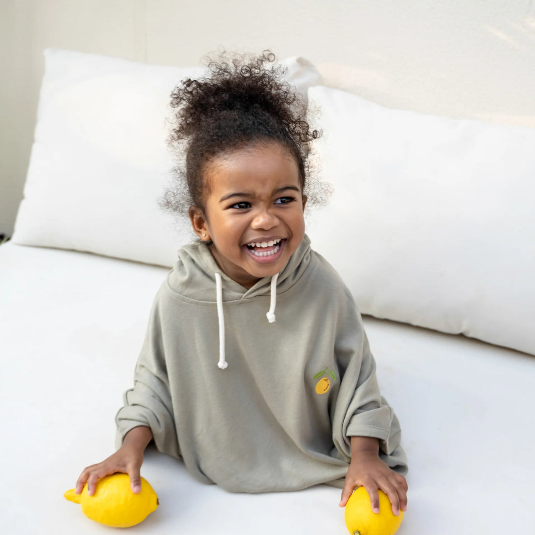 Toddler wearing Cosy Roots Organic UV Poncho - Khaki