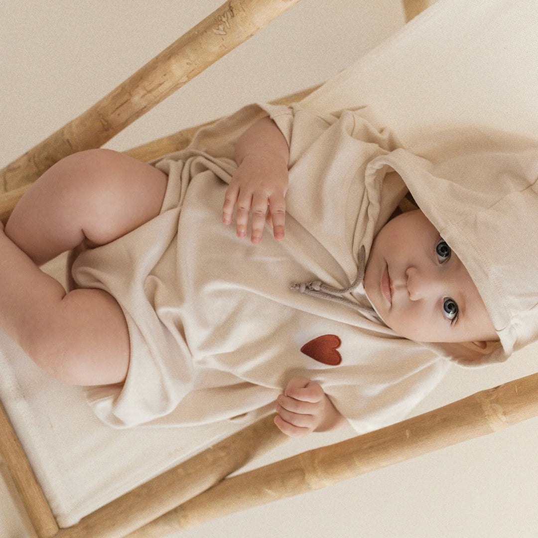 Baby wearing Cosy Roots Organic UV Poncho - Sand