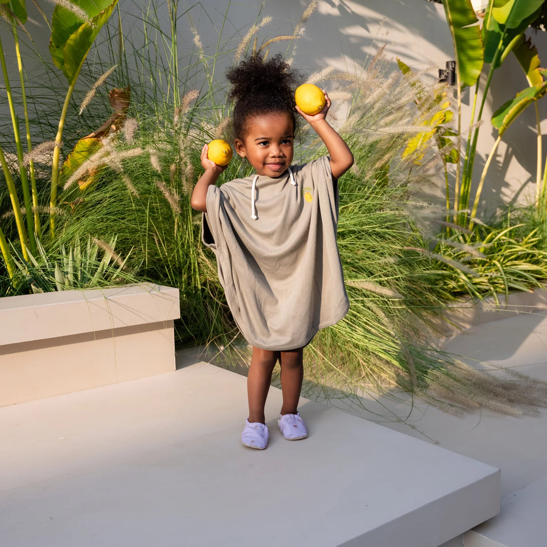 Toddler wearing Cosy Roots Organic UV Poncho - Khaki