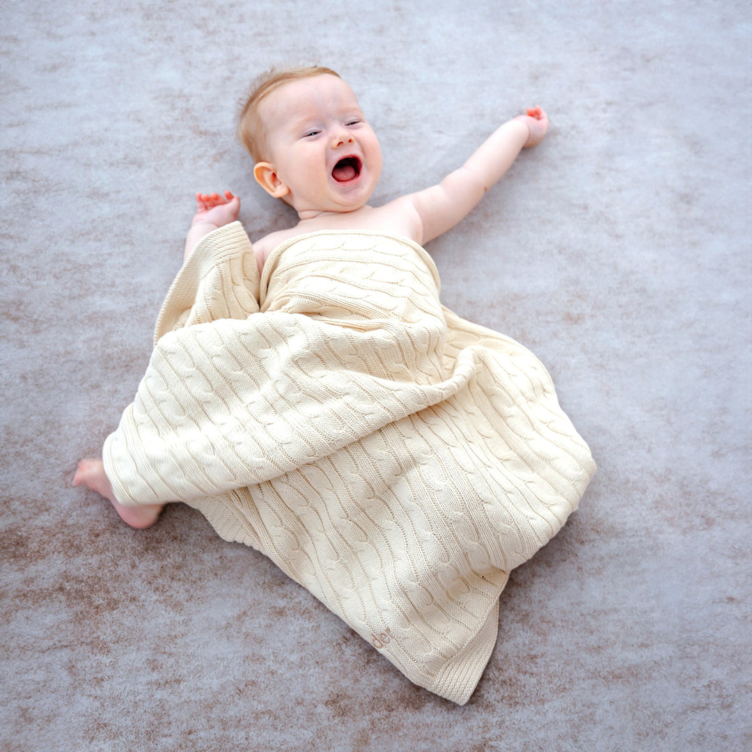 Baby using Cream Cable Knit Blanket 