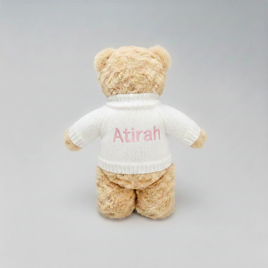 Soft plush teddy bear gift for Eid with custom name on jumper.