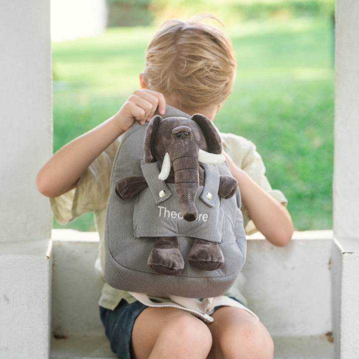 Boy opening elephant bag with "Theodore" personalised in cream thread