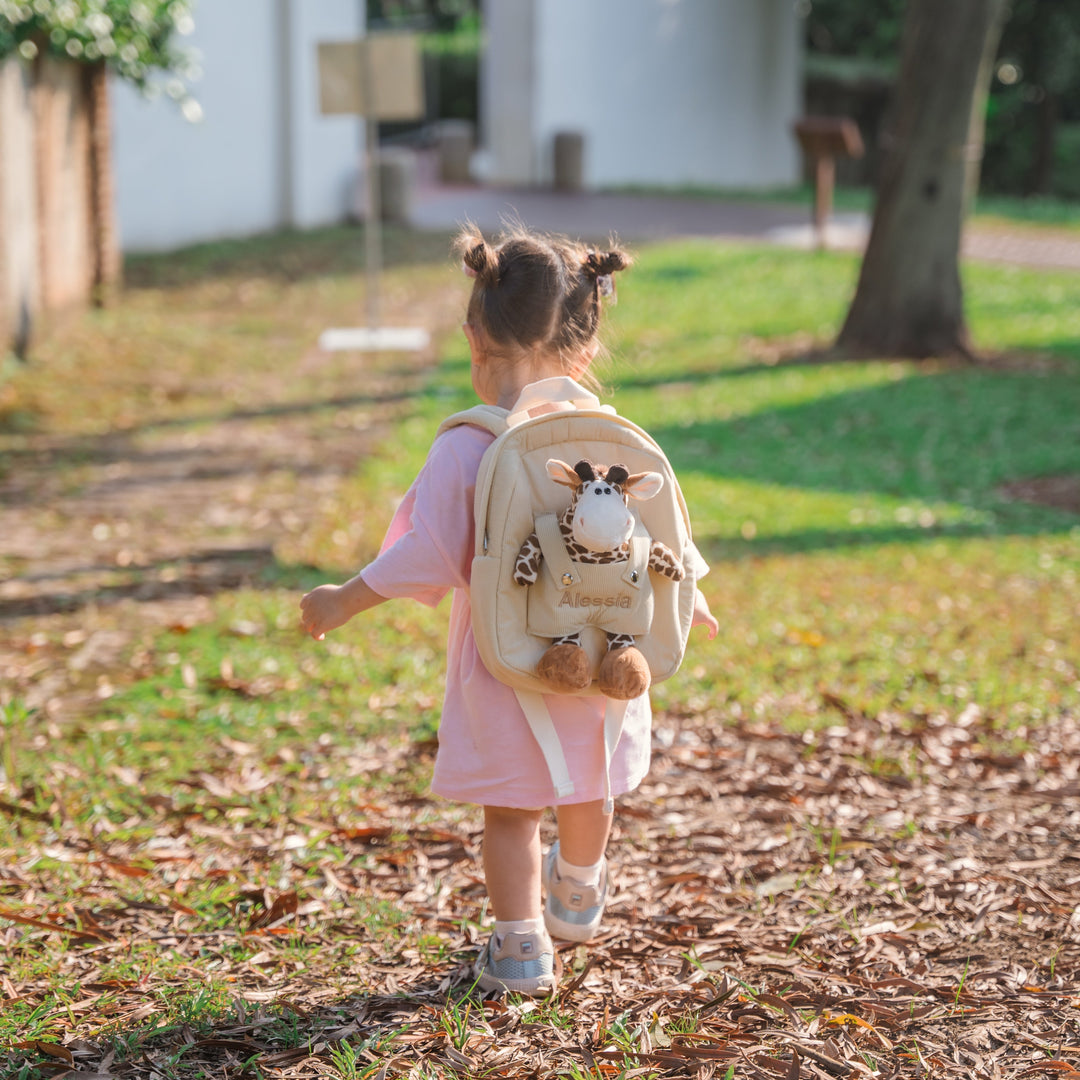 Girl carrying giraffe bag personalised in pink thread