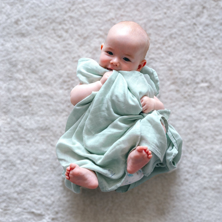 Baby covering in Green Bamboo Swaddle