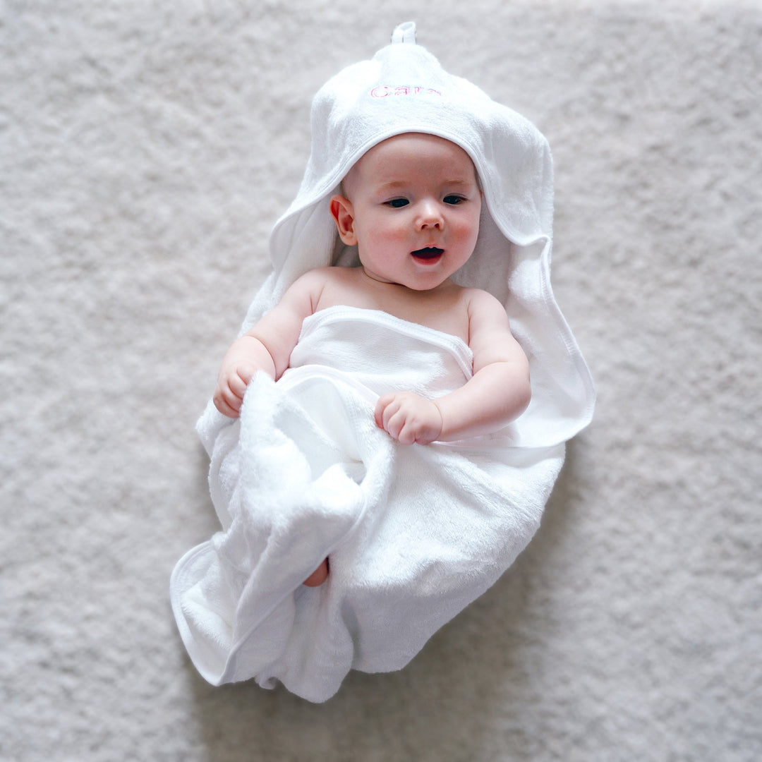 Baby wearing a hooded towel with the name "Gaia" embroidered on the hood