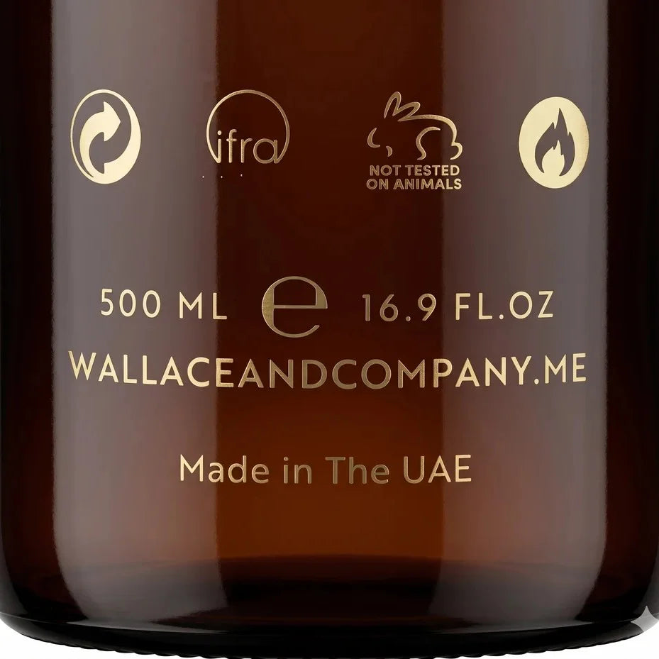 Close-up of an amber glass bottle with gold printed text and icons