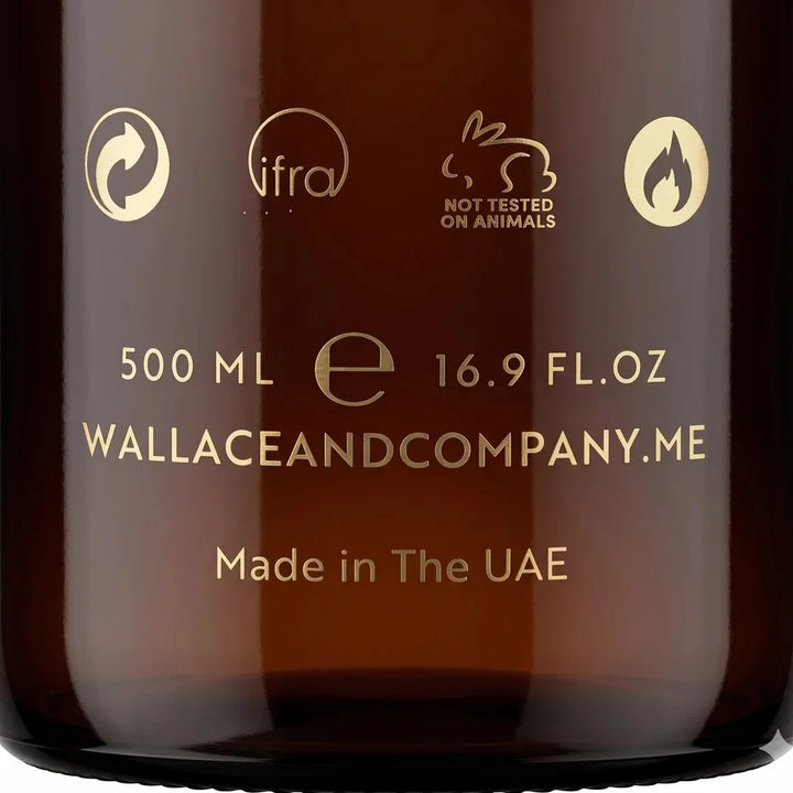 Close-up of an amber glass bottle with gold printed text and icons