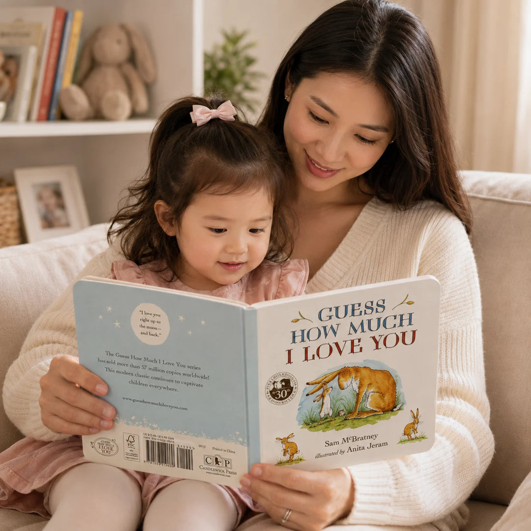 Mother Reading Guess How Much I Love You Board Book with Her Toddler in a Cosy Home Setting