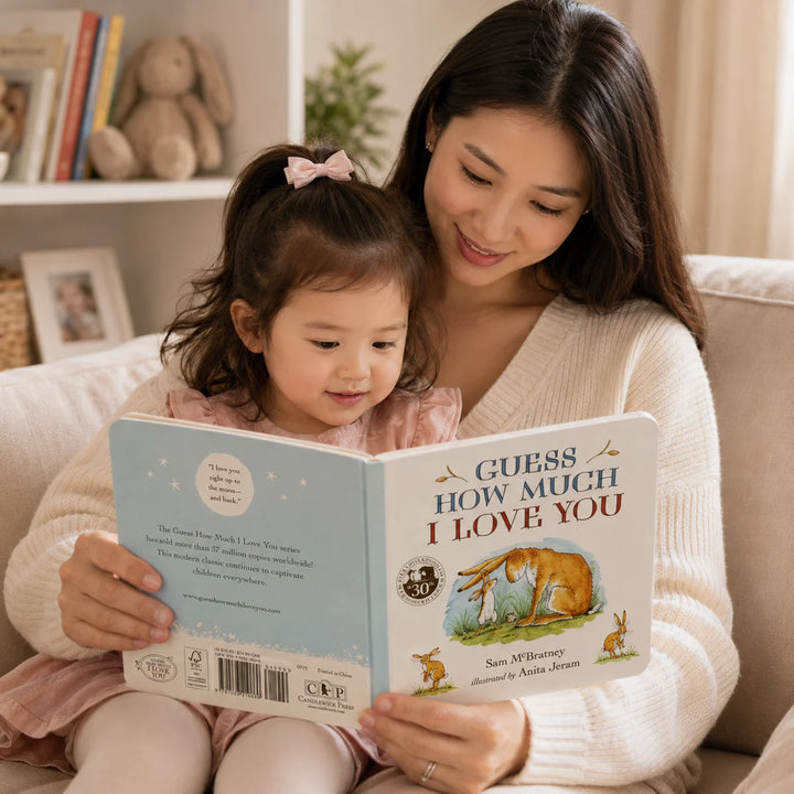 Mother Reading Guess How Much I Love You Board Book with Her Toddler in a Cosy Home Setting