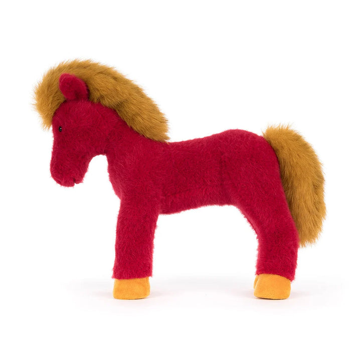Side profile of the Jellycat Festival Horse plush, featuring a bright red body, fluffy golden mane and tail, and golden hooves.