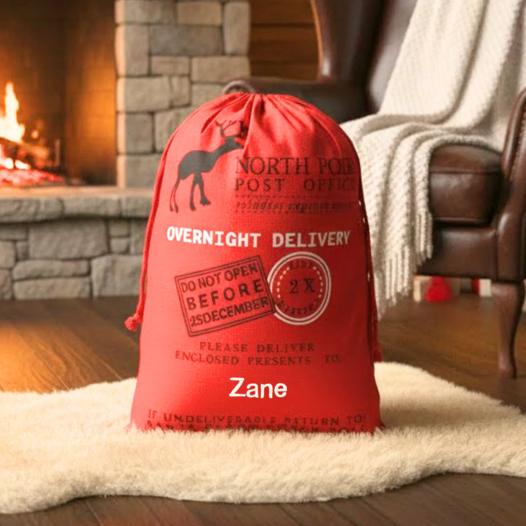 Red Christmas sack labeled 'Zane' in a cozy living room with a fireplace.