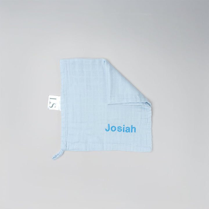 Light blue muslin washcloth with 'Josiah' embroidered