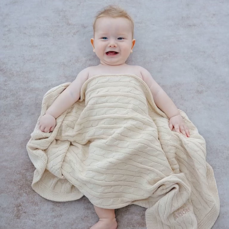 Short Video of Baby covering with Cream Cable Knit Blanket 