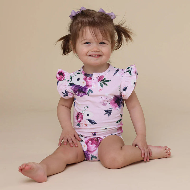 Toddler wearing Snuggle Hunny Floral Kiss Short Sleeve Organic Bodysuit with Frill