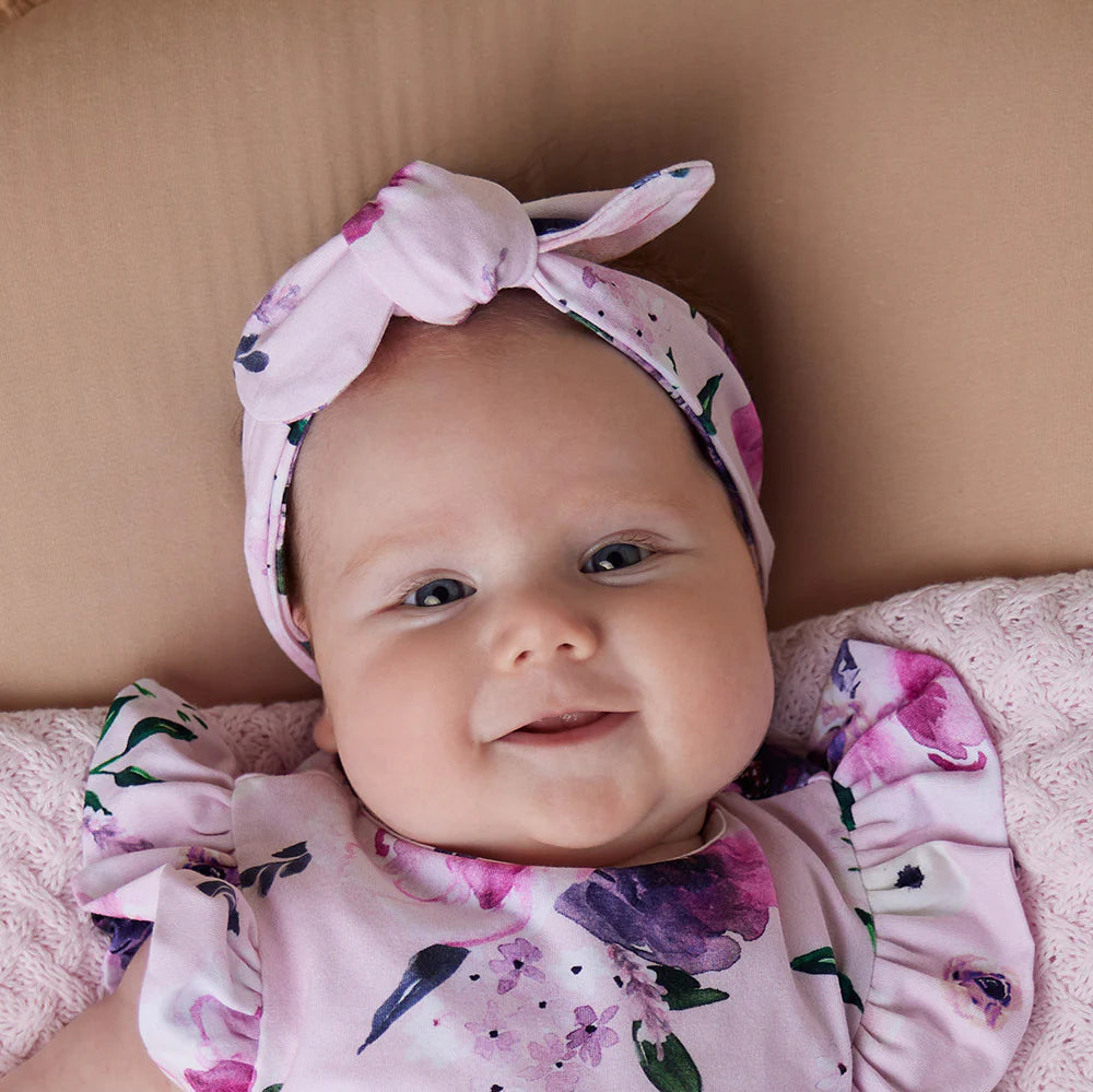 Baby wearing Snuggle Hunny Floral Kiss Organic Topknot
