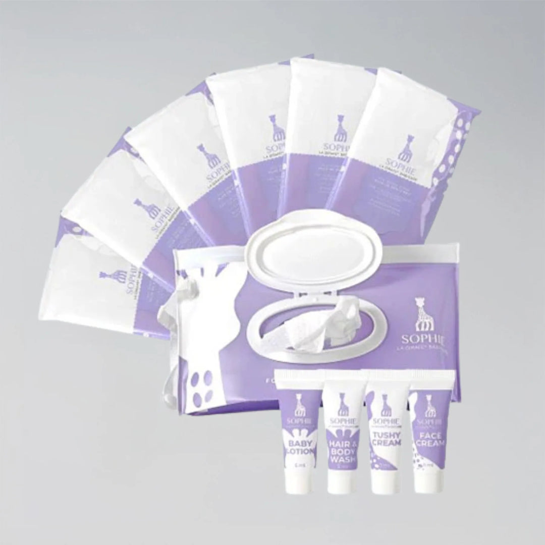 Set of Sophie la girafe Babycare products including wipes and bottles on a gray background