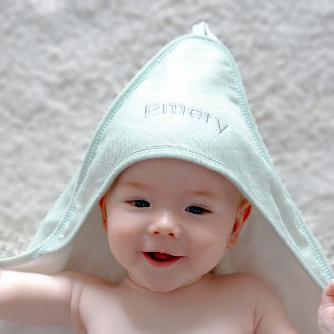 Baby covering in Green Bamboo Hooded Towel with "Emery" customised in Grey thread