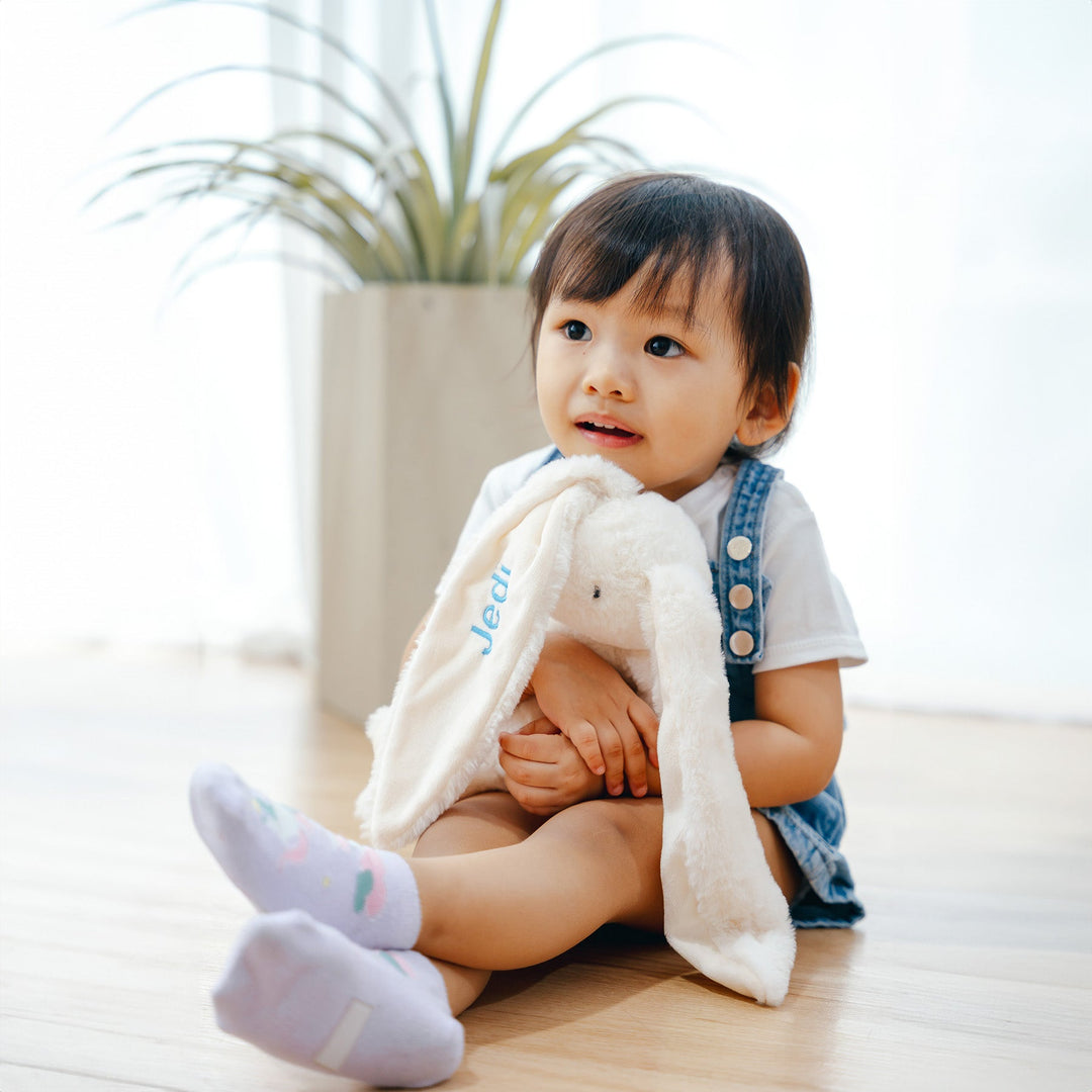 baby playing with personalised bunny 