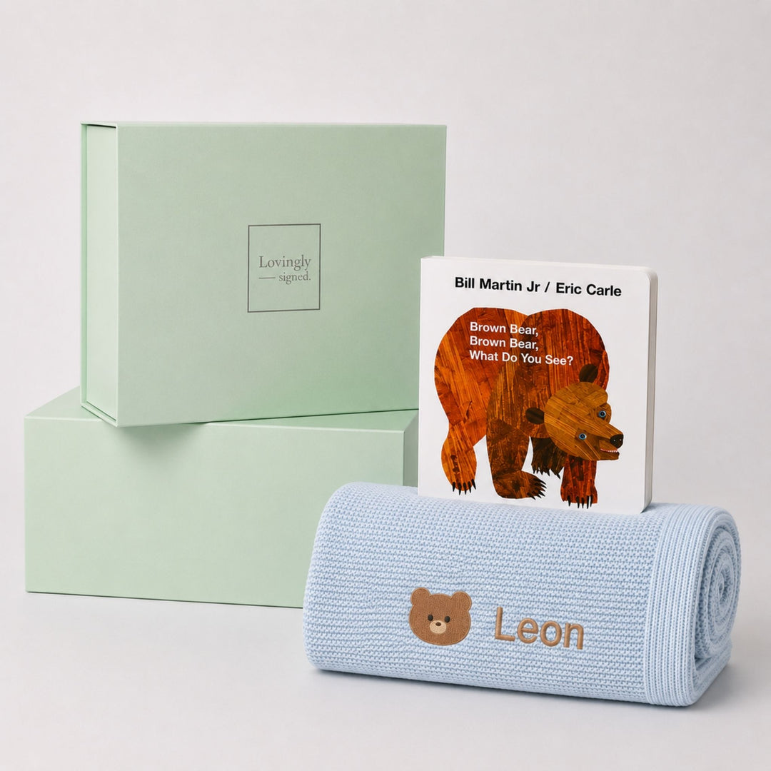 Personalised blue bamboo blanket embroidered with a teddy bear motif and the name Leon, paired with Brown Bear, Brown Bear, What Do You See? and a Lovingly Signed gift box.
