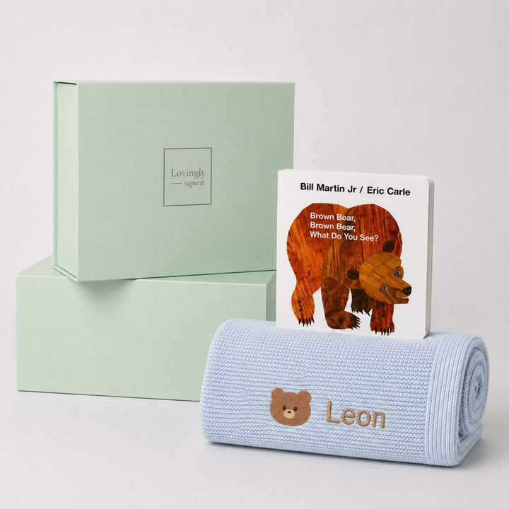 Personalised blue bamboo blanket embroidered with a teddy bear motif and the name Leon, paired with Brown Bear, Brown Bear, What Do You See? and a Lovingly Signed gift box.