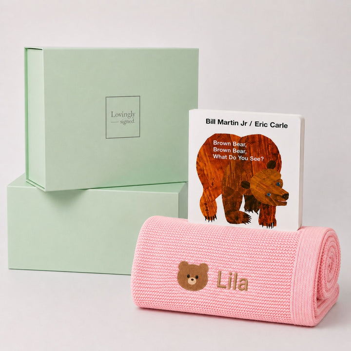 Personalised pink knit baby blanket embroidered with a teddy bear motif and the name Lila, paired with Brown Bear, Brown Bear, What Do You See? and a Lovingly Signed gift box.