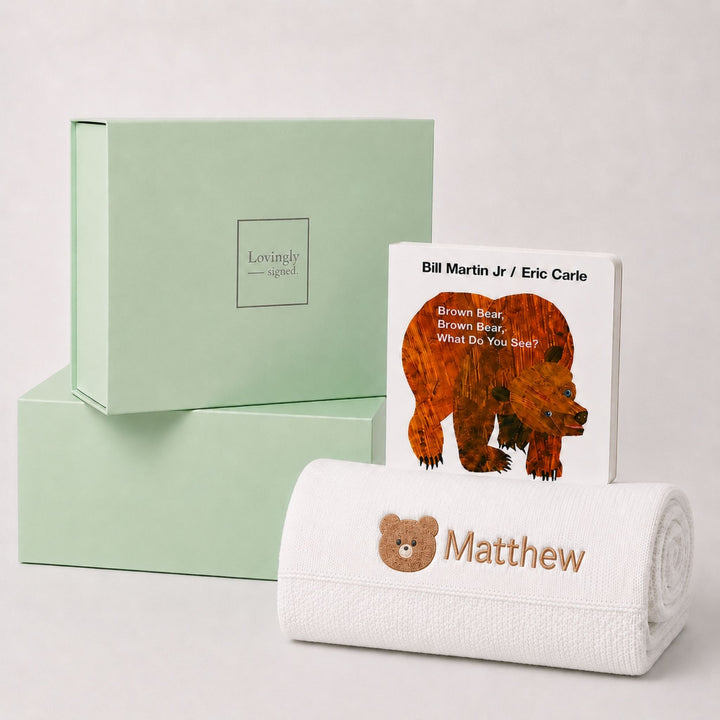 Personalised white knit baby blanket embroidered with a teddy bear motif and the name Matthew, paired with Brown Bear, Brown Bear, What Do You See? and a Lovingly Signed gift box.