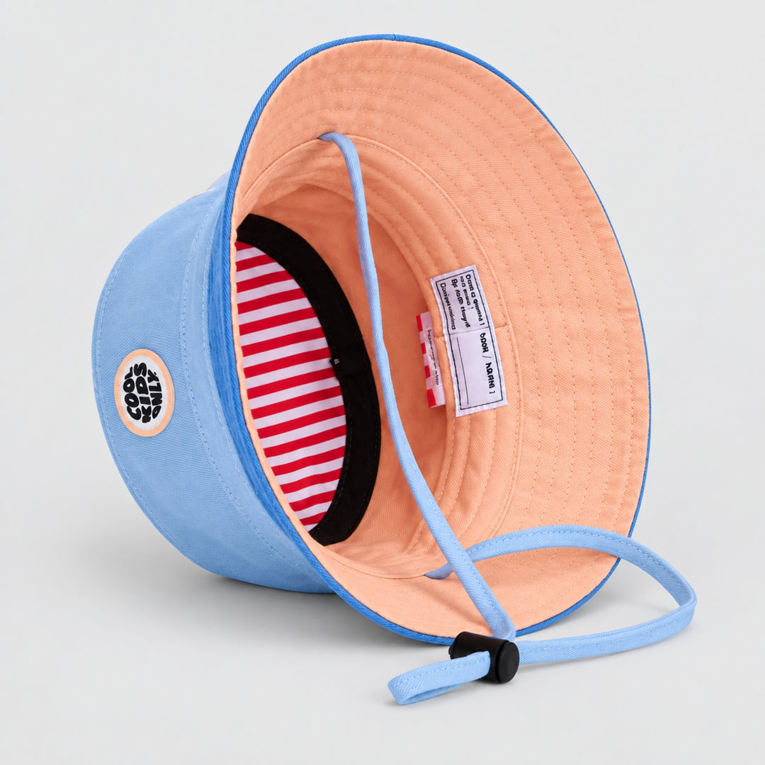 Interior view of the Hello Hossy blue bucket hat showing peach lining, striped inner band, chin strap and product label.
