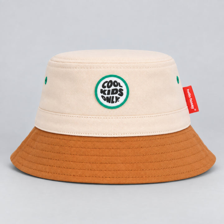 Hello Hossy cream and brown bucket hat with “Cool Kids Only” front patch and red side tag.