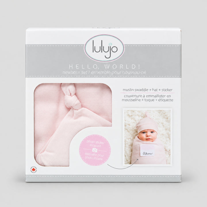 Lulujo Hello World pink newborn gift set in retail packaging, including muslin swaddle, matching hat and photo announcement sticker.