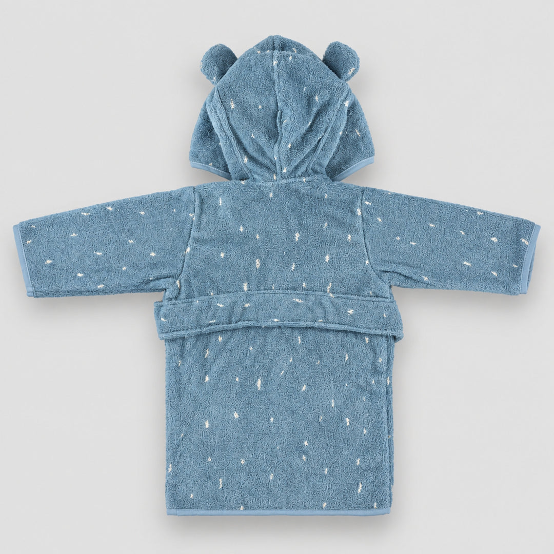 Back view of the dusty blue children’s elephant bathrobe laid flat on a seamless light grey studio background. The robe features a hood with rounded elephant ears, white speckled detailing, long sleeves, and a matching waist belt.