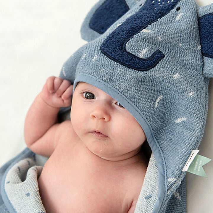 Baby wrapped in a blue Trixie Elephant hooded towel, soft absorbent baby bath towel UAE