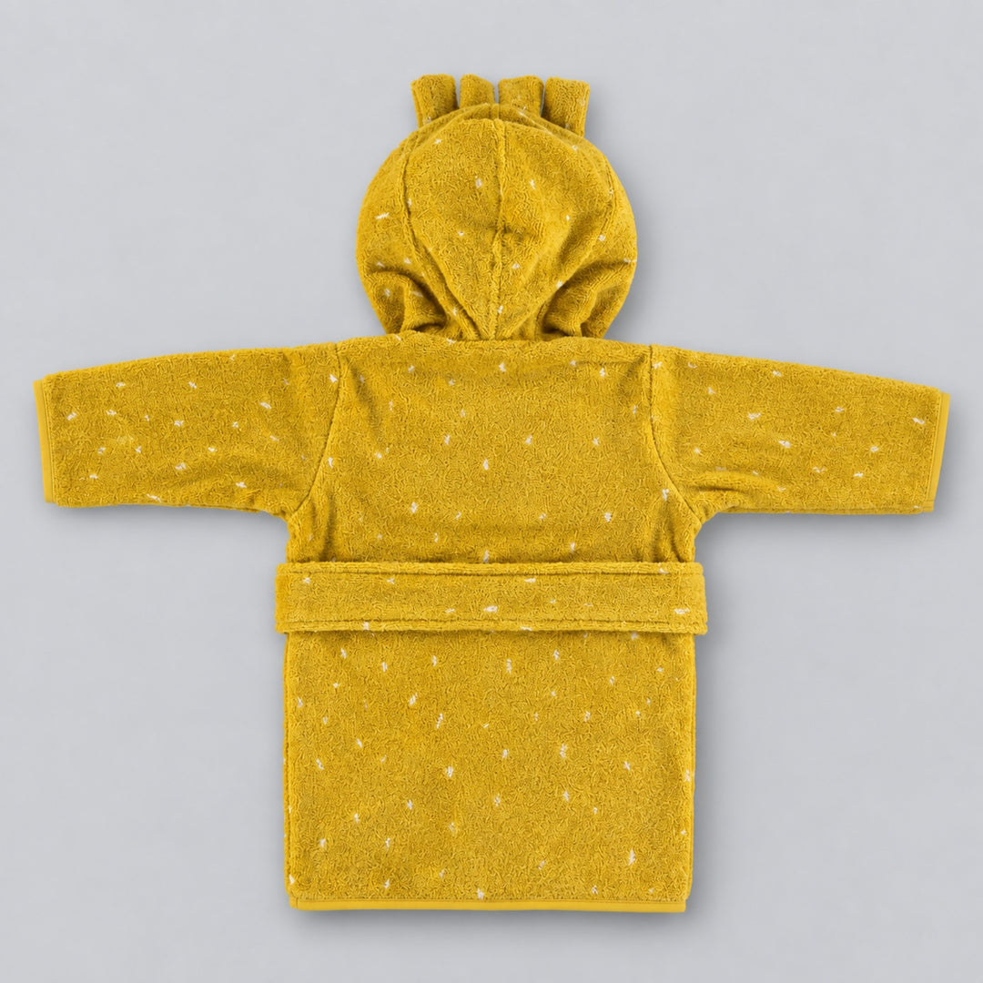 Back view of a mustard yellow children’s lion bathrobe laid flat on a light grey studio background, featuring a hood with small mane details, white speckled pattern, long sleeves and matching waist belt.